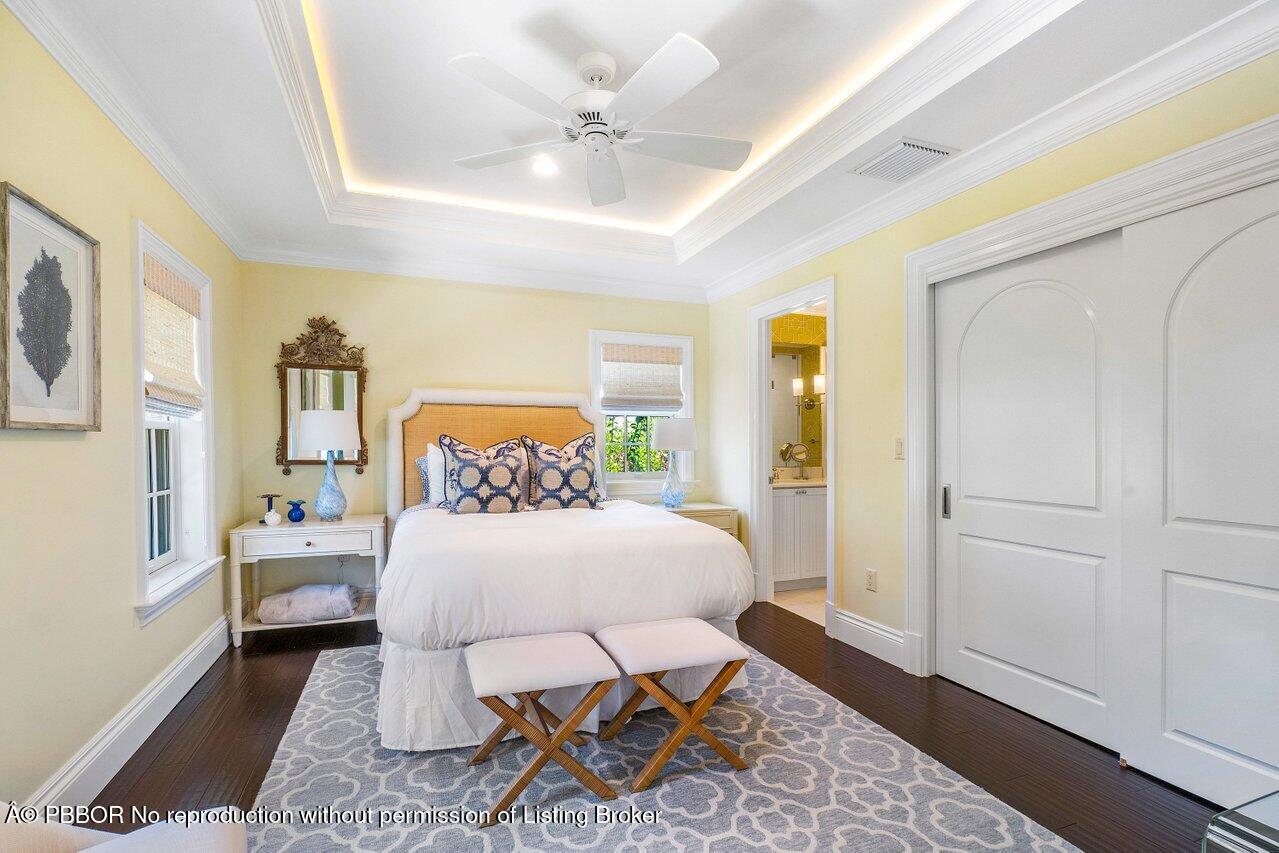 134 Seagate Road Palm Beach, FL 33480 - Photo 20 of 29 a bedroom with a bed and wooden floor