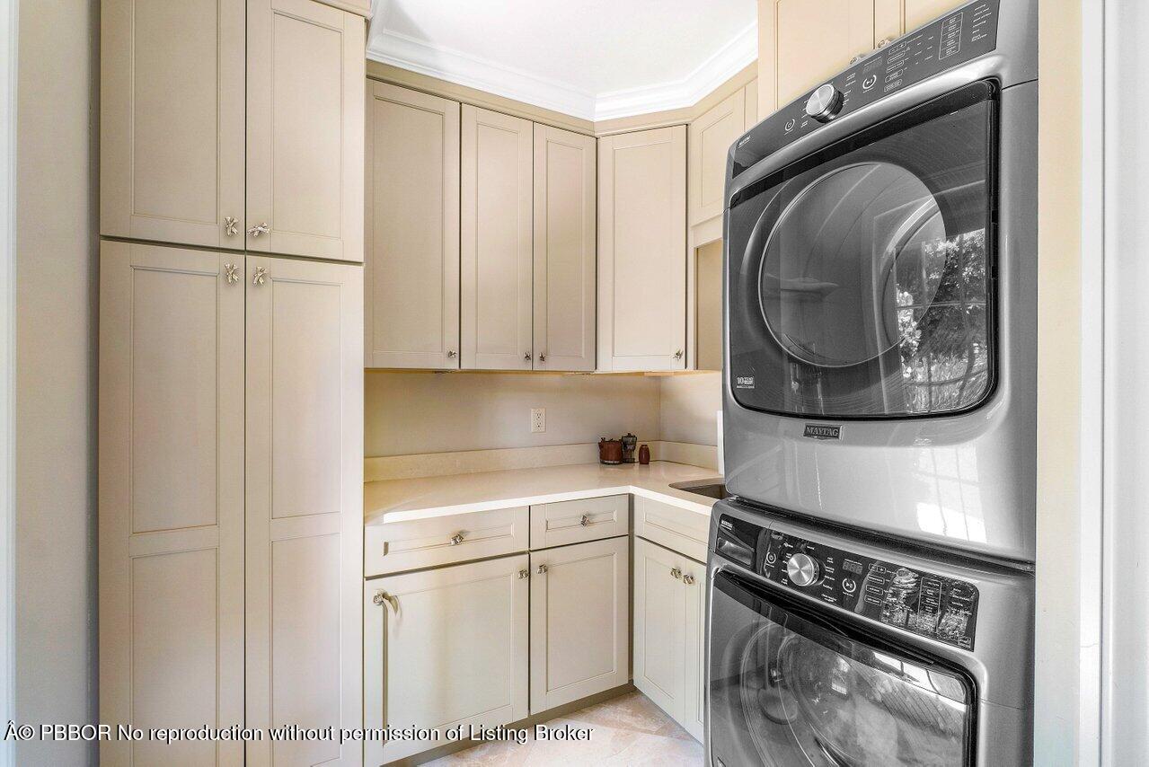 134 Seagate Road Palm Beach, FL 33480 - Photo 25 of 29 a kitchen with a white stove and white cabinets