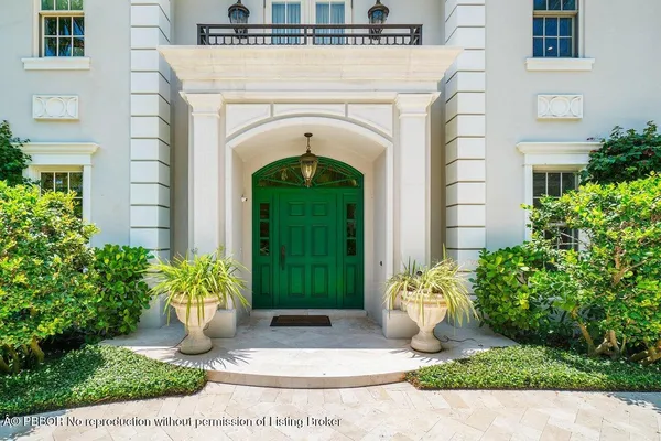 a view of a house with potted plants