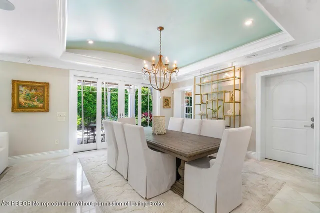 a view of a dining room with furniture wooden floor and chandelier