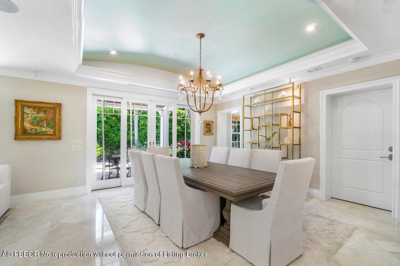134 Seagate Road Palm Beach, FL 33480 - Photo 9 of 29 a view of a dining room with furniture wooden floor and chandelier