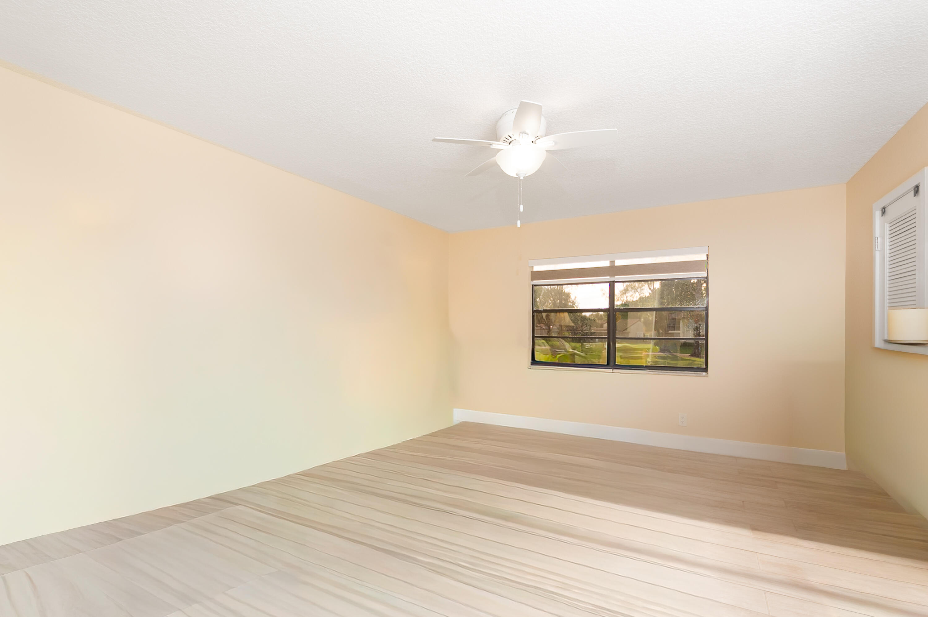 21703 Tall Palm Circle, Unit 5D Boca Raton, FL 33433 - Photo 20 of 36 an empty room with wooden floor and window
