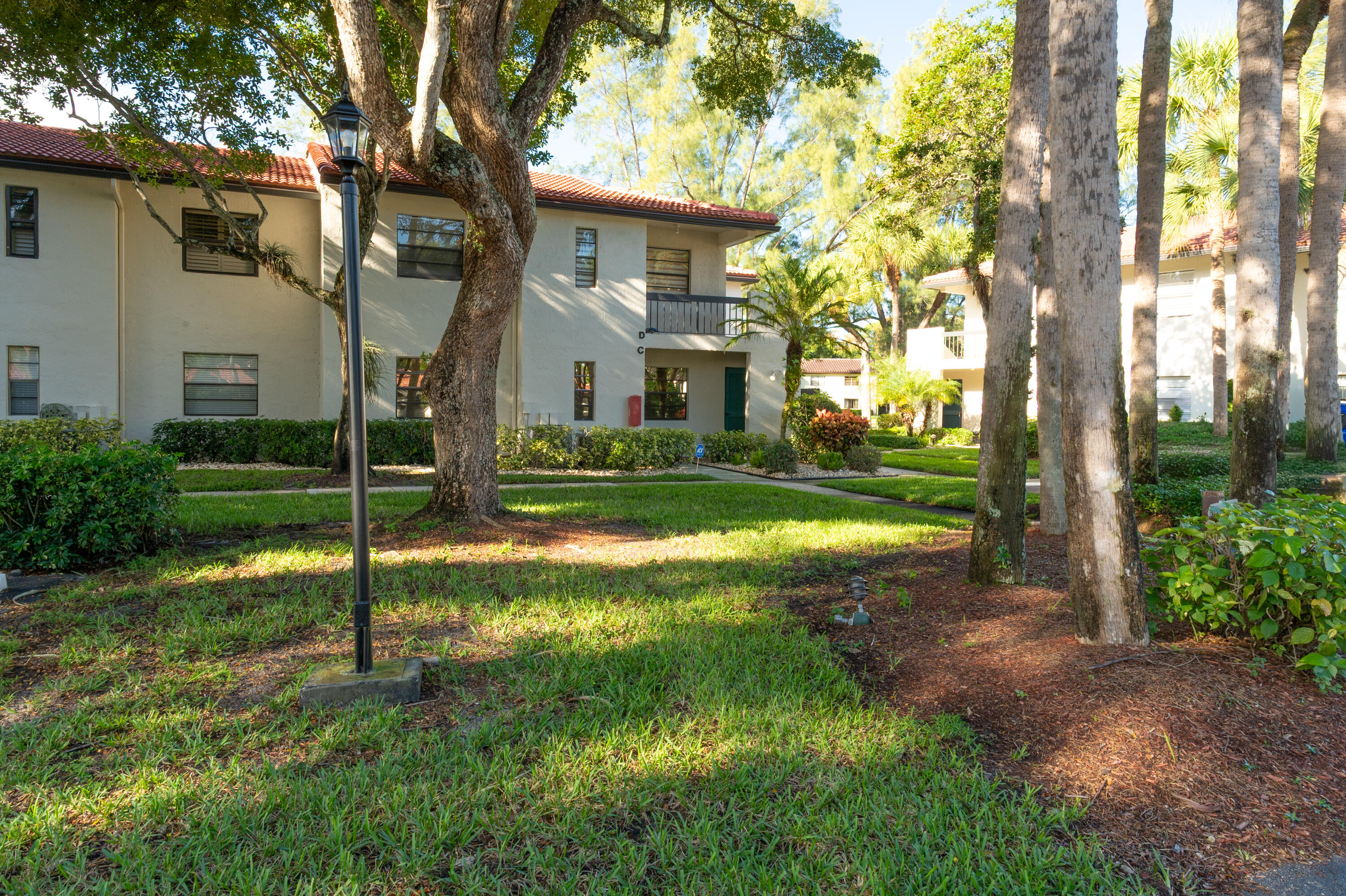 21703 Tall Palm Circle, Unit 5D Boca Raton, FL 33433 - Photo 25 of 36 a view of a house with a yard