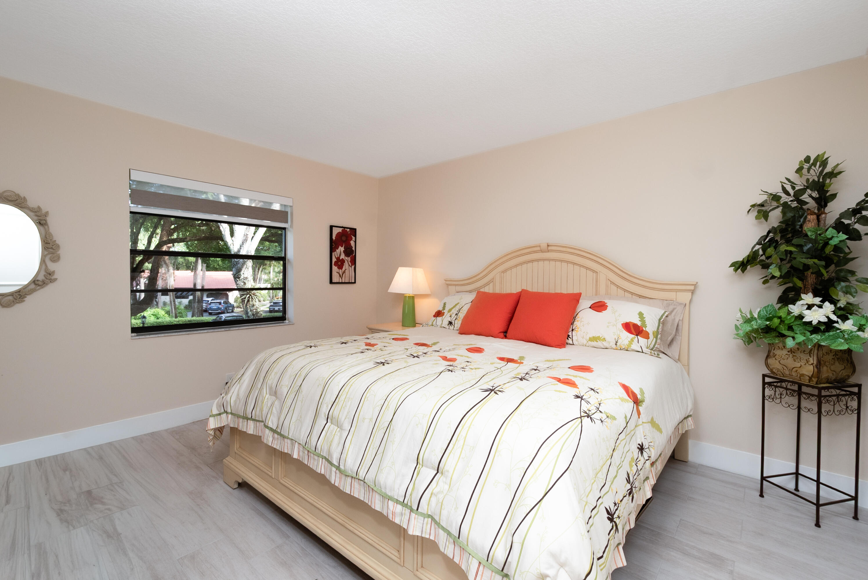 21703 Tall Palm Circle, Unit 5D Boca Raton, FL 33433 - Photo 26 of 36 a bedroom with a bed and a painting on the wall