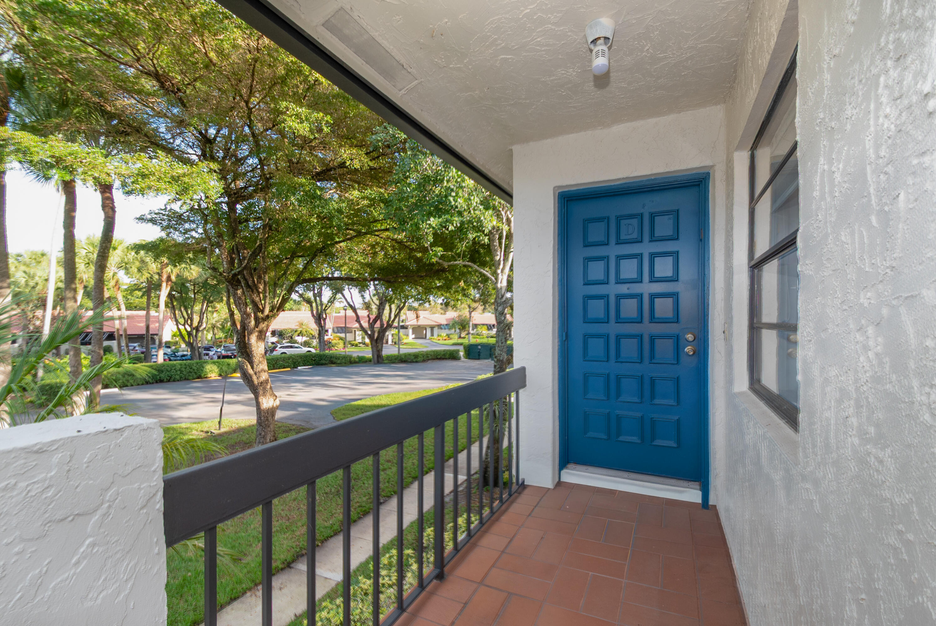 21703 Tall Palm Circle, Unit 5D Boca Raton, FL 33433 - Photo 3 of 36 a view of a porch and a yard