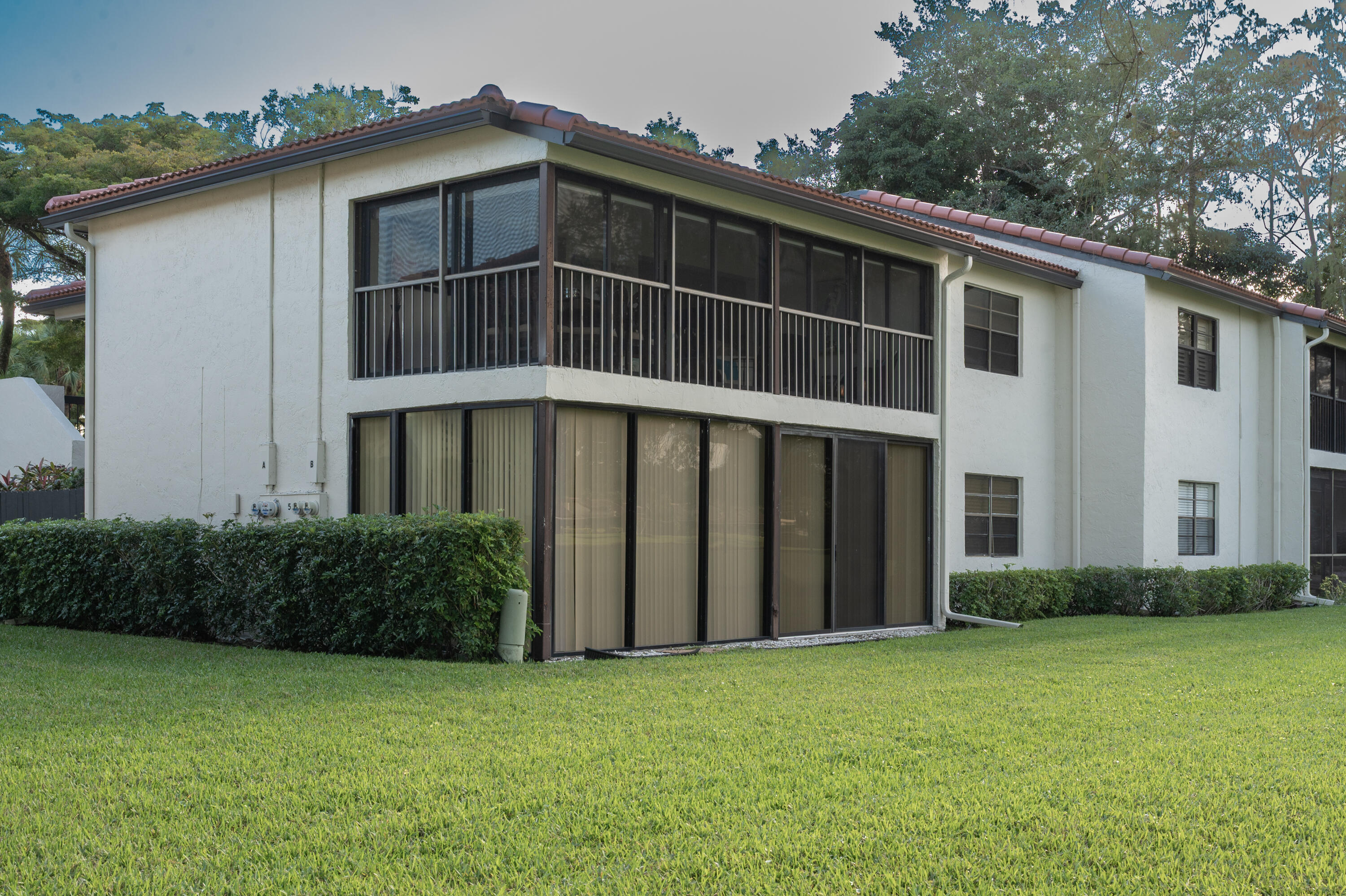 21703 Tall Palm Circle, Unit 5D Boca Raton, FL 33433 - Photo 32 of 36 a front view of a house with garage