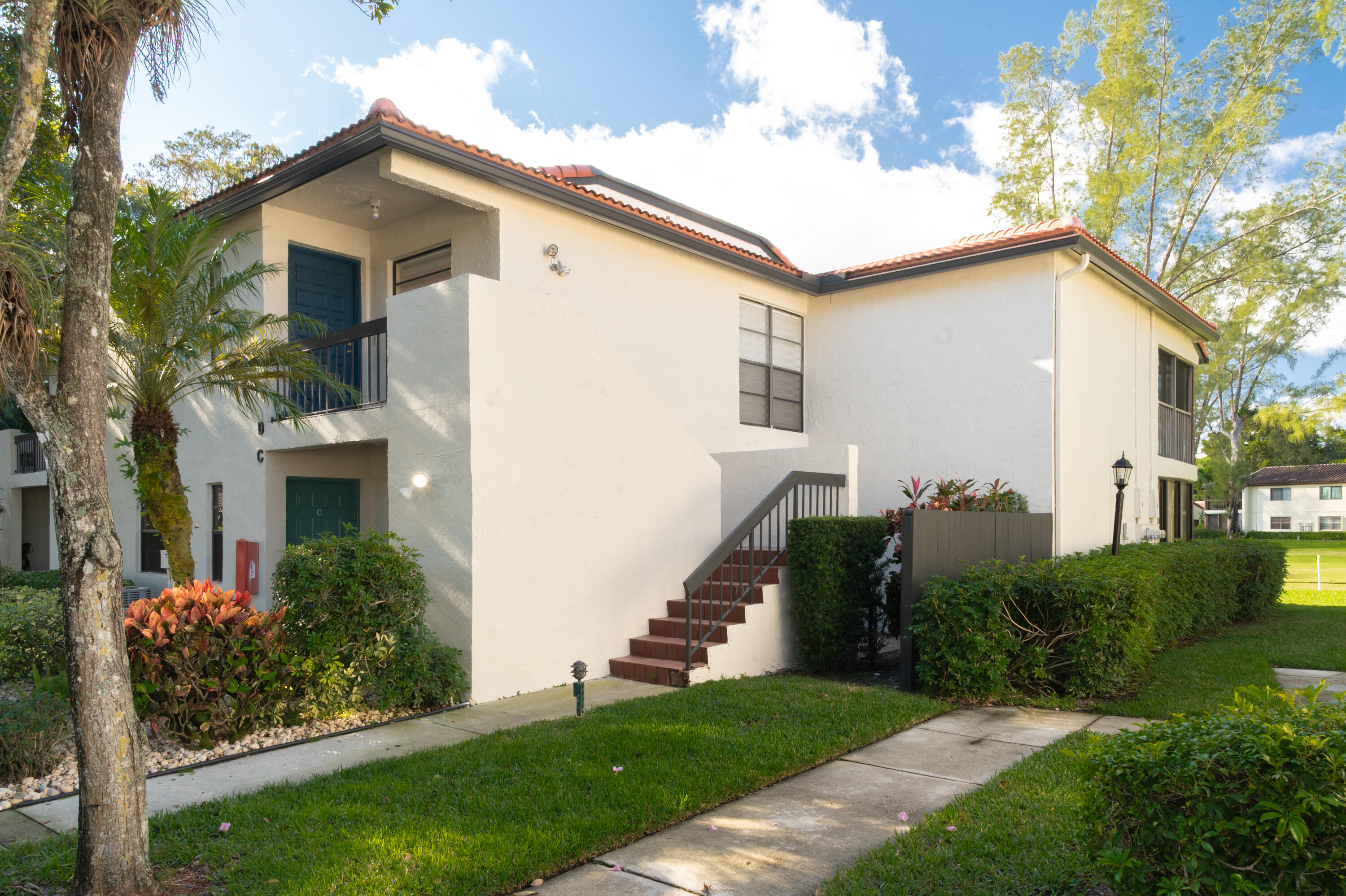 21703 Tall Palm Circle, Unit 5D Boca Raton, FL 33433 - Photo 33 of 36 a front view of a house with a yard