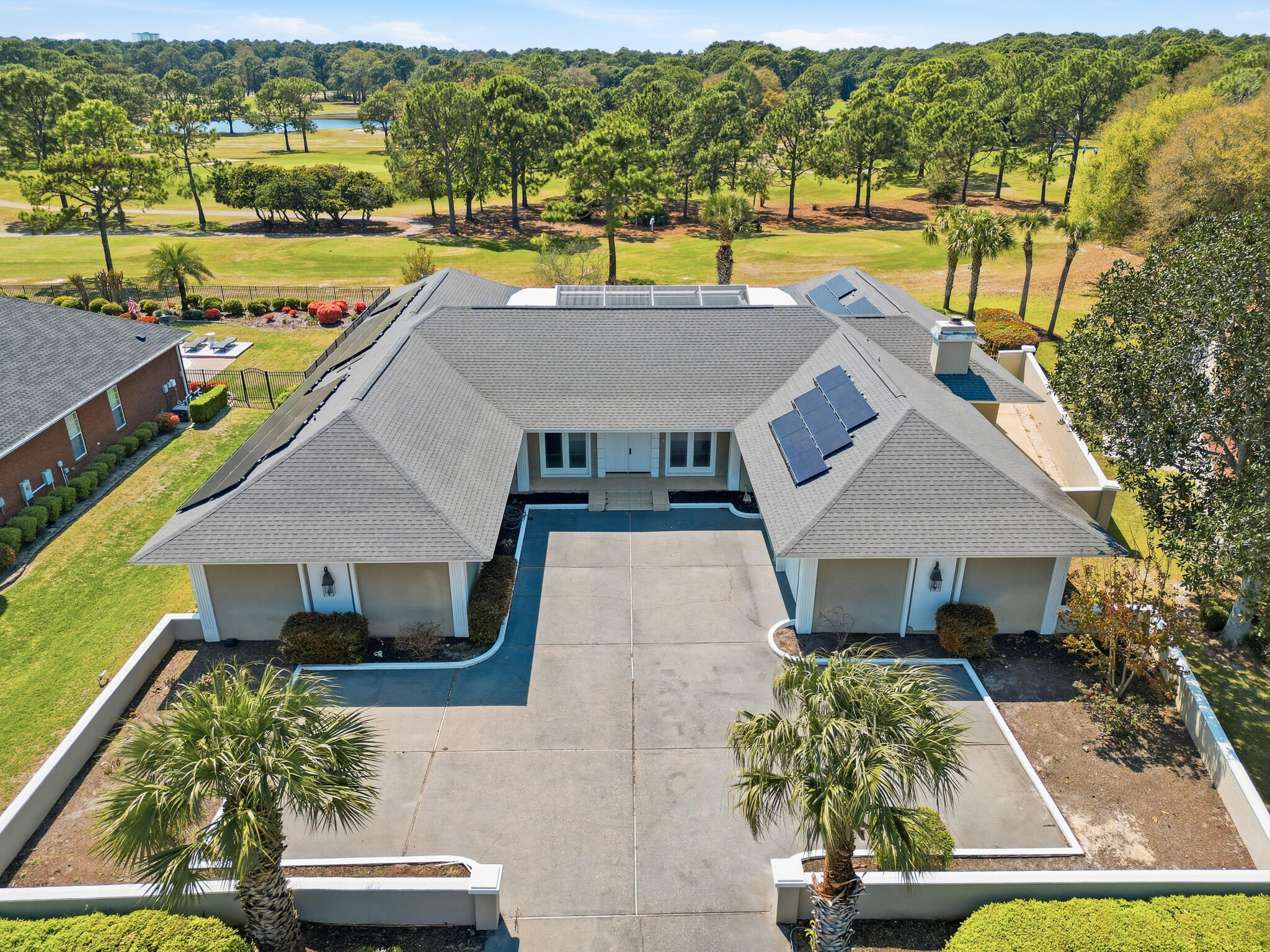 an aerial view of a house with a yard swimming pool and outdoor seating
