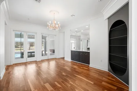 a big room with wooden floor and windows