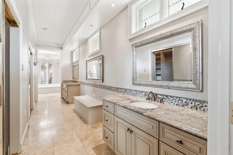 a bathroom with a double vanity sink and a mirror