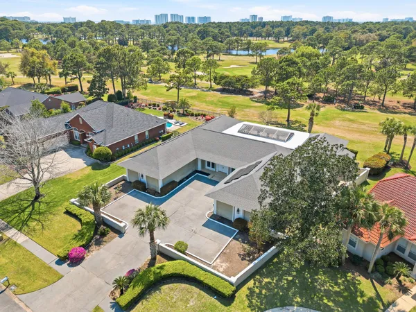 an aerial view of residential houses with outdoor space and ocean view
