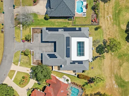 aerial view of a house with swimming pool and sitting area