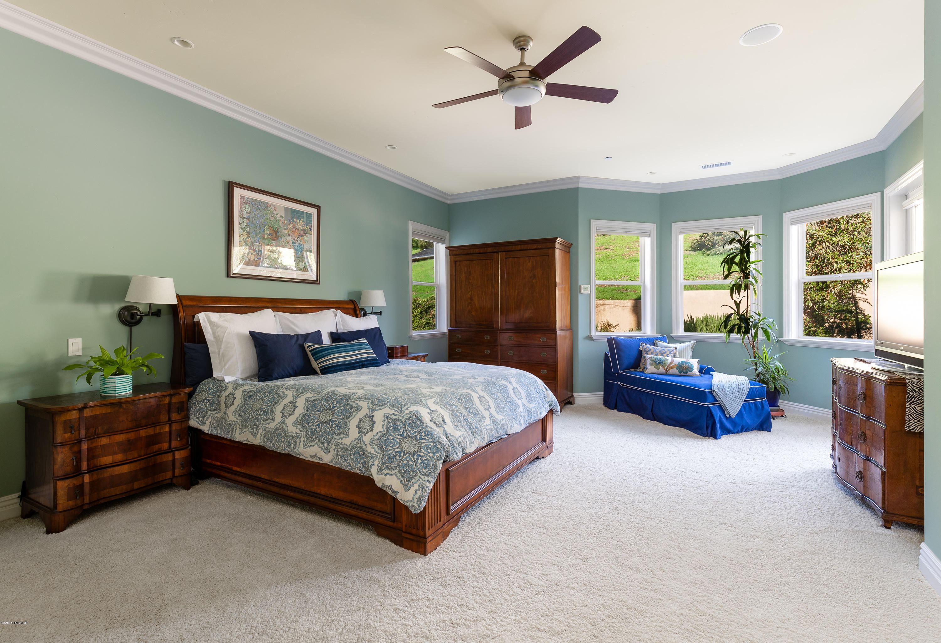 949 Old Ranch Road Solvang, CA 93463 - Photo 11 of 27 a spacious bedroom with a bed a couch and a large window
