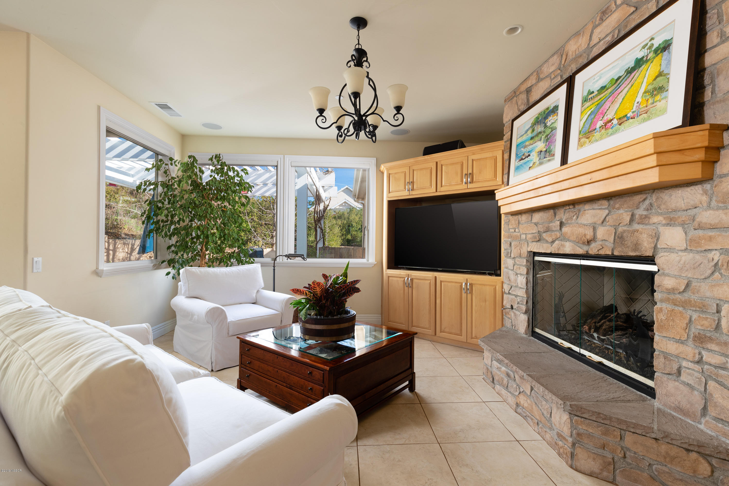 949 Old Ranch Road Solvang, CA 93463 - Photo 7 of 27 a living room with furniture a flat screen tv and a fireplace