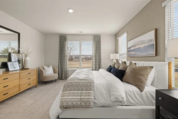 a large bedroom with a bed and large window