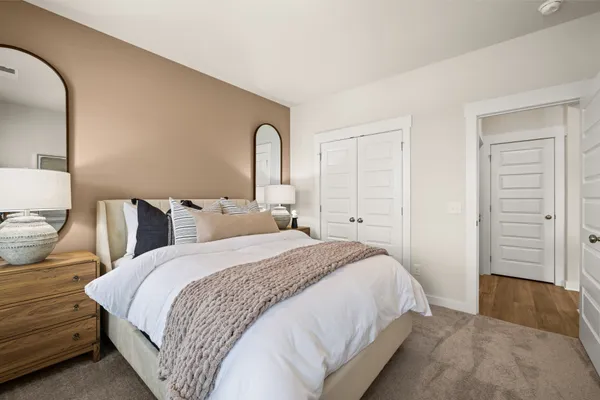 a spacious bedroom with a bed and a window