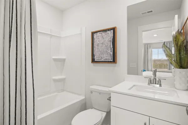 a bedroom with a bed and a potted plant