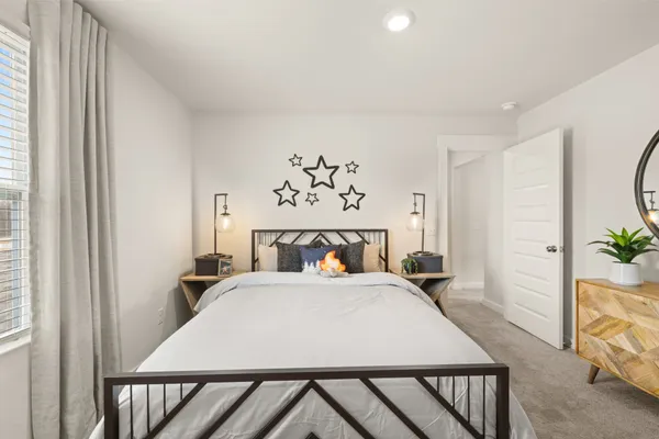 a bedroom with a bed and a potted plant