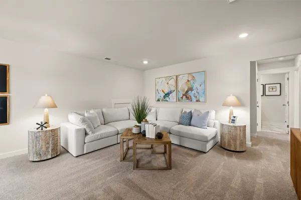 a living room with furniture and kitchen view