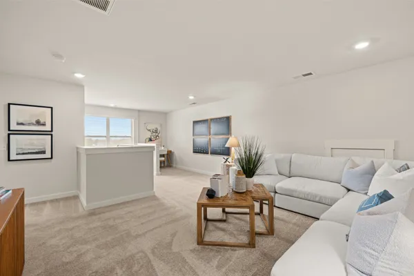 a room with two chair and white wooden cabinets
