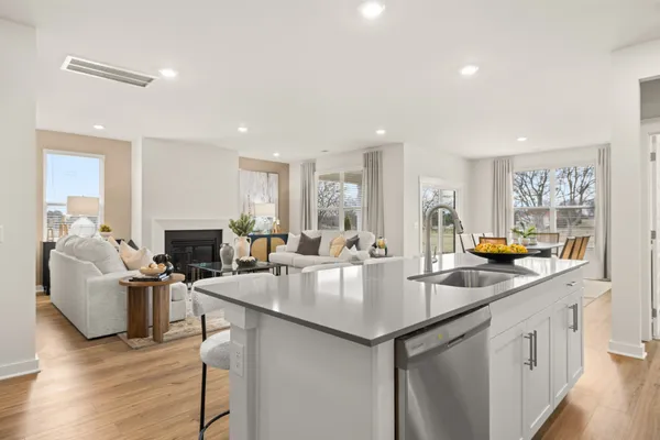 a kitchen with a sink appliances and cabinets