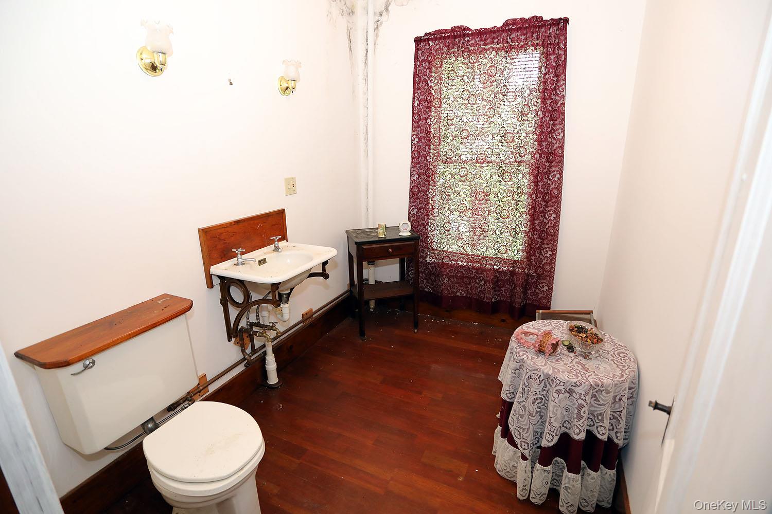50 Parsonage Road Cochecton, NY 12726 - Photo 19 of 21 Half bath with wood finished floors and toilet