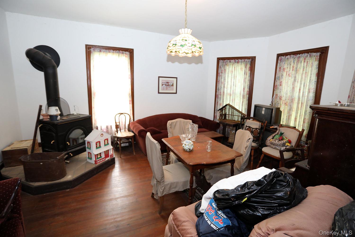 50 Parsonage Road Cochecton, NY 12726 - Photo 7 of 21 Living Room has a woodstove and beautiful floors, plenty of natural light, and a wood stove