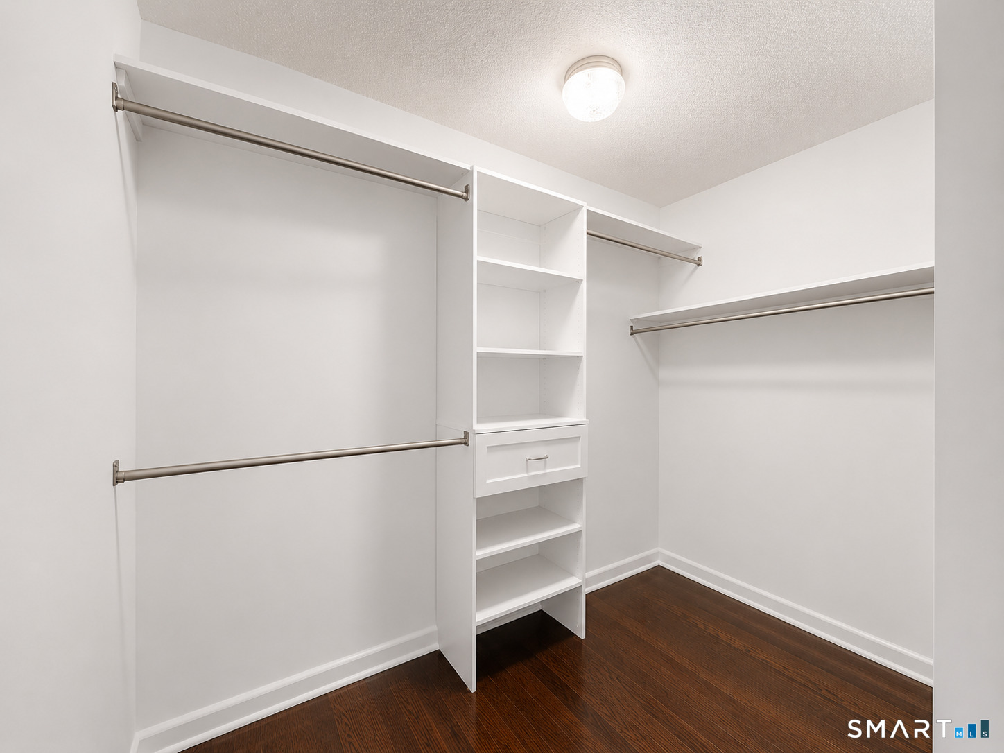 914 High Path Road, Unit 914 Windsor, CT 06095 - Photo 13 of 23 a view of an empty walk in closet with wooden floor