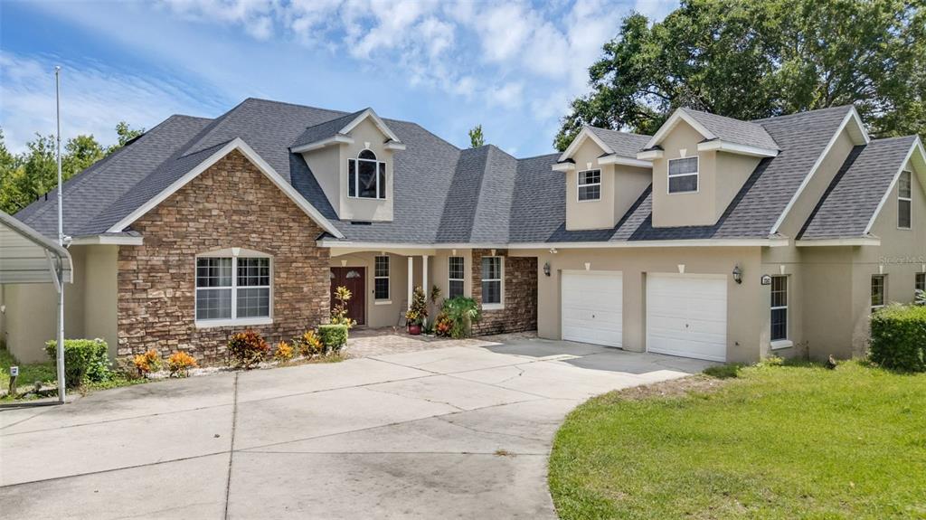 2202 Old Tavares Road Leesburg, FL 34748 - Photo 1 of 1 a front view of a house with a garden