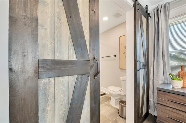 a view of walk in closet and bathroom