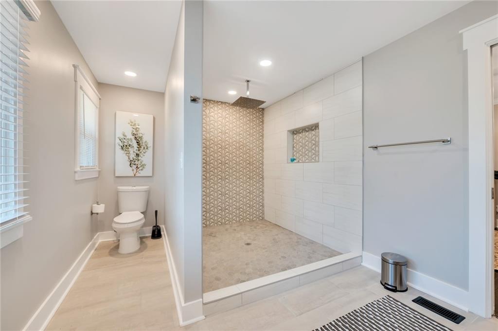 345 Pine Grove Road Roswell, GA 30075 - Photo 16 of 30 a bathroom with a granite countertop toilet sink and shower