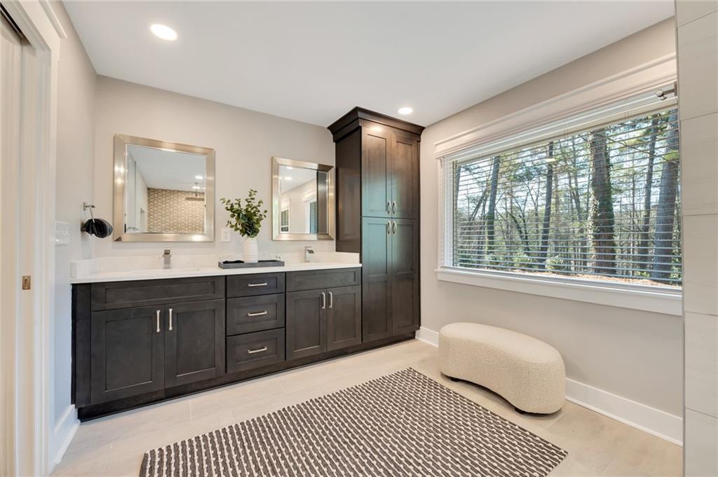 345 Pine Grove Road Roswell, GA 30075 - Photo 17 of 30 a spacious bathroom with a vanity a sink a mirror a bathtub and window