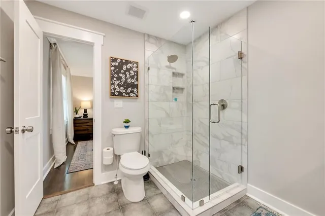 a bathroom with a shower and toilet