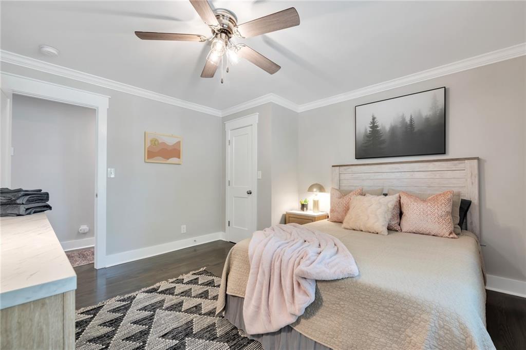 345 Pine Grove Road Roswell, GA 30075 - Photo 26 of 30 a bedroom with a large bed and a chandelier