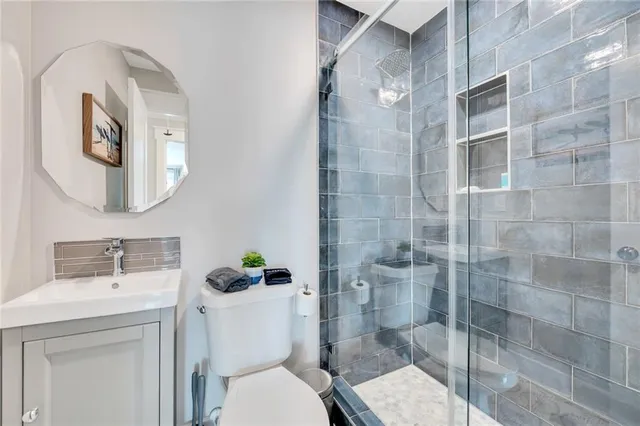 a bathroom with a toilet sink and shower