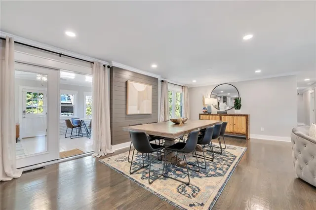 a view of a dining room with furniture and wooden floor