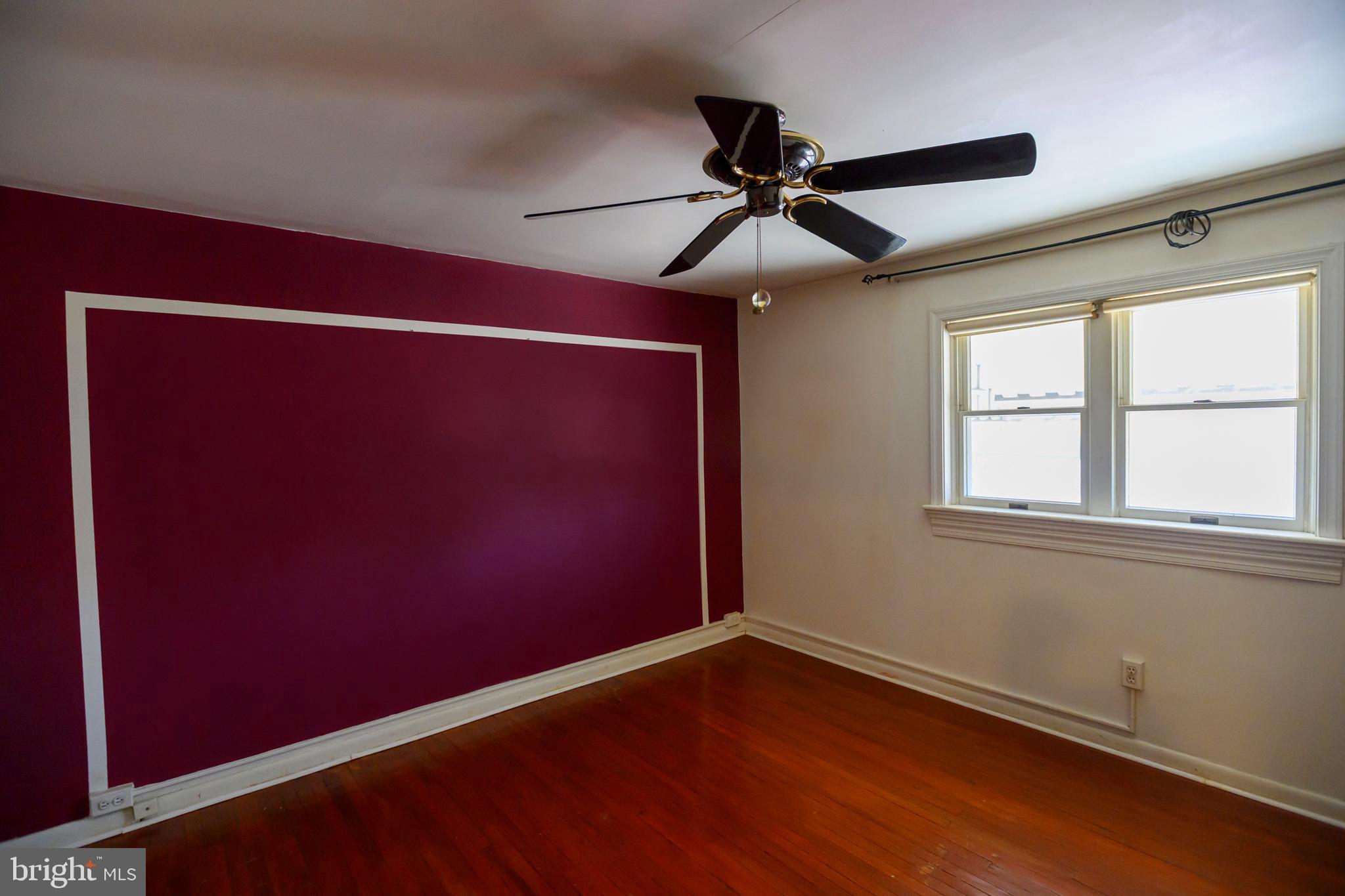 127 Sherbrook Boulevard Upper Darby, PA 19082 - Photo 11 of 24 an empty room with wooden floor fan and windows