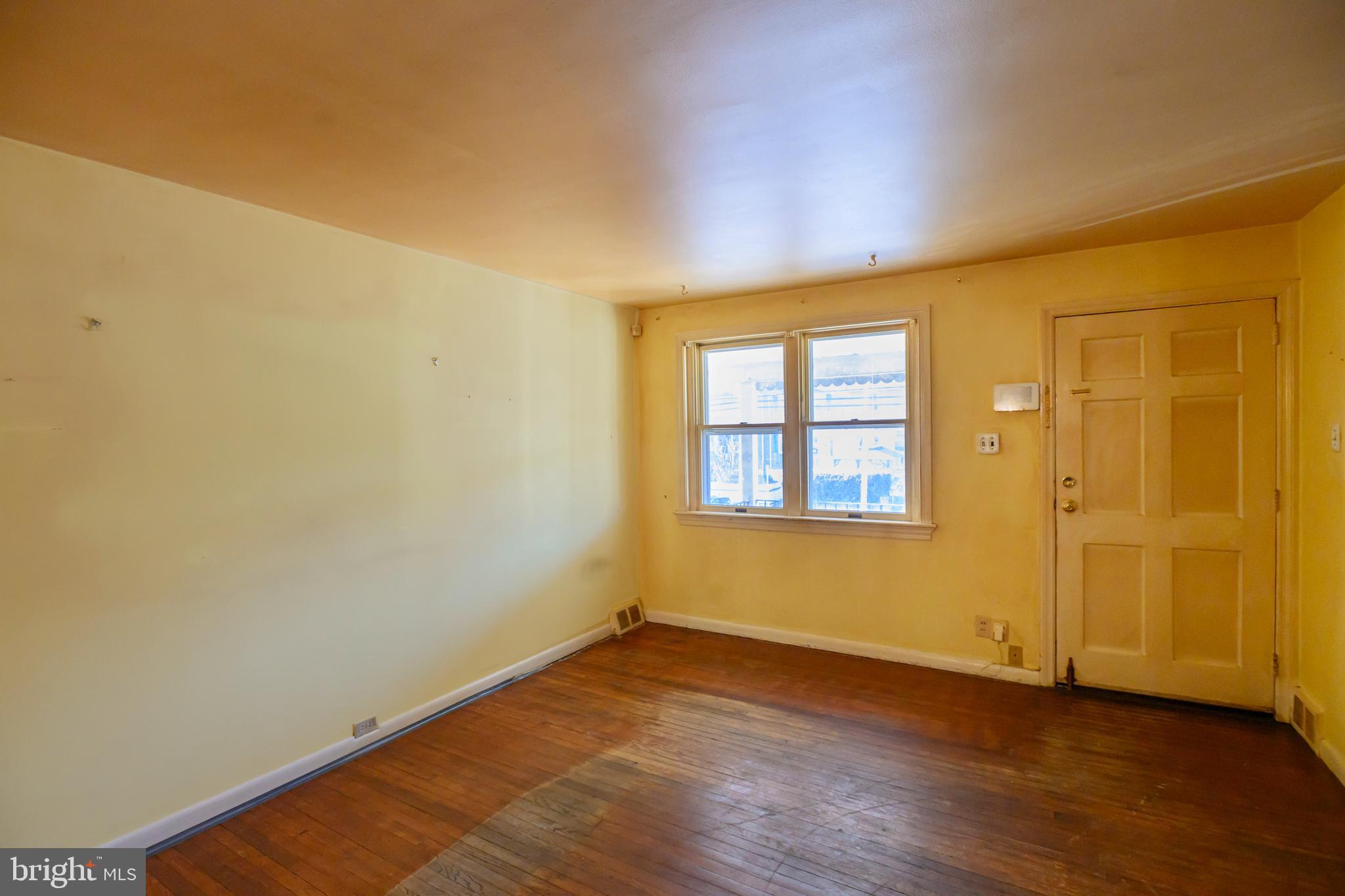 127 Sherbrook Boulevard Upper Darby, PA 19082 - Photo 3 of 24 an empty room with wooden floor and windows