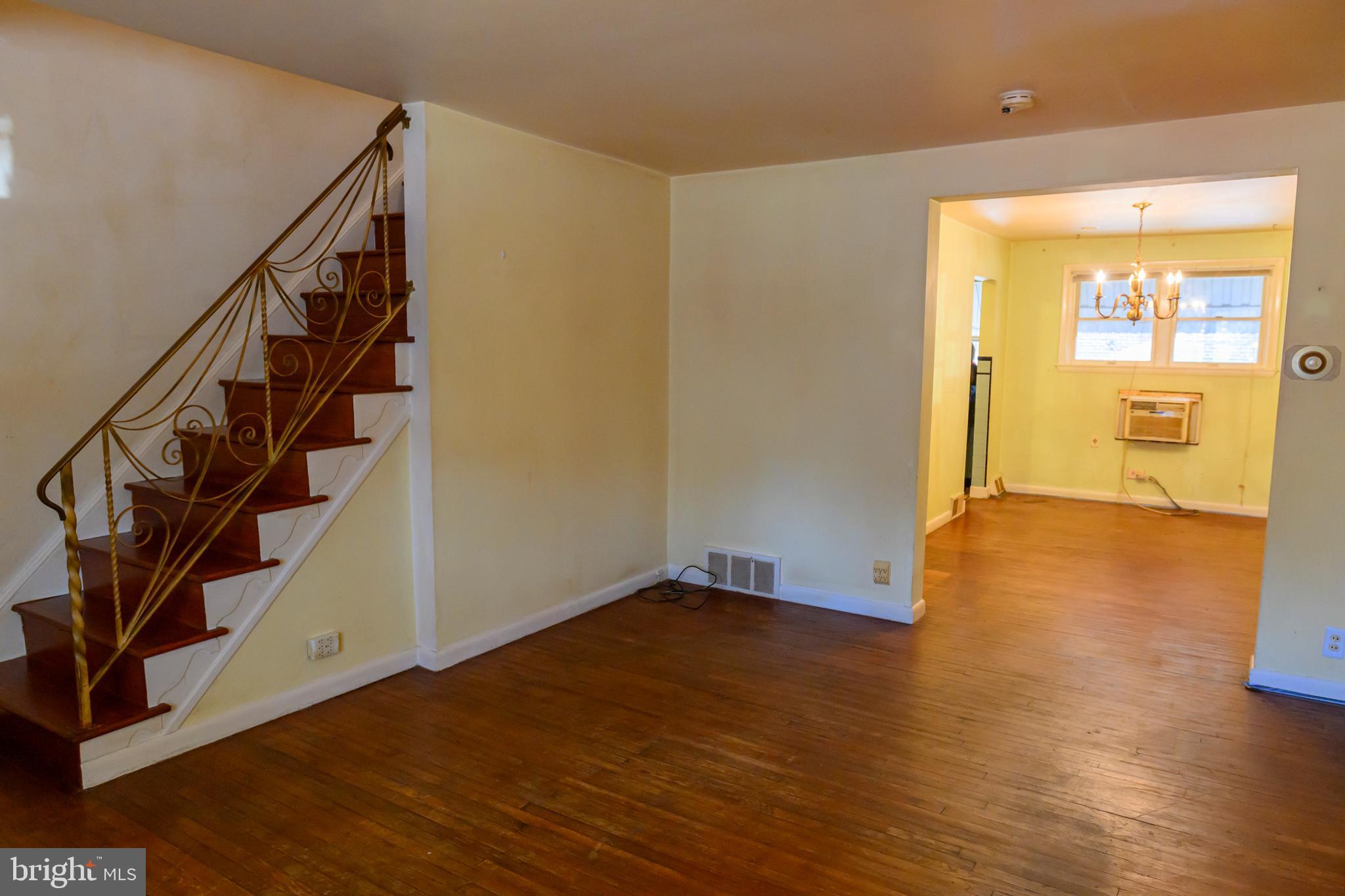 127 Sherbrook Boulevard Upper Darby, PA 19082 - Photo 5 of 24 a view of an empty room with wooden floor and stairs