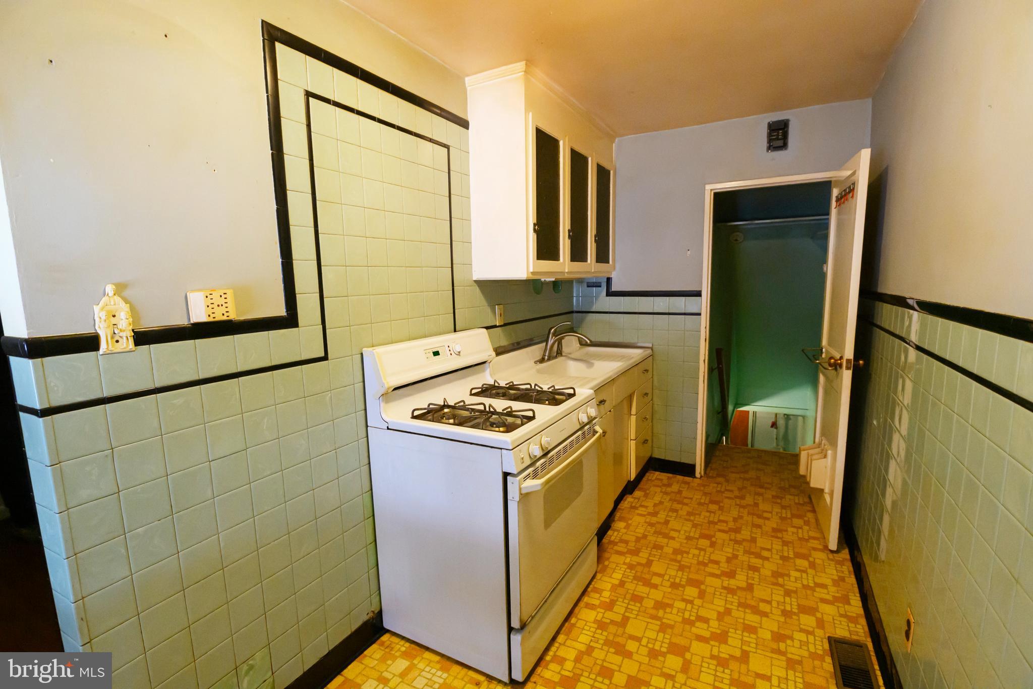 127 Sherbrook Boulevard Upper Darby, PA 19082 - Photo 10 of 24 a kitchen with a stove top oven sink and a refrigerator