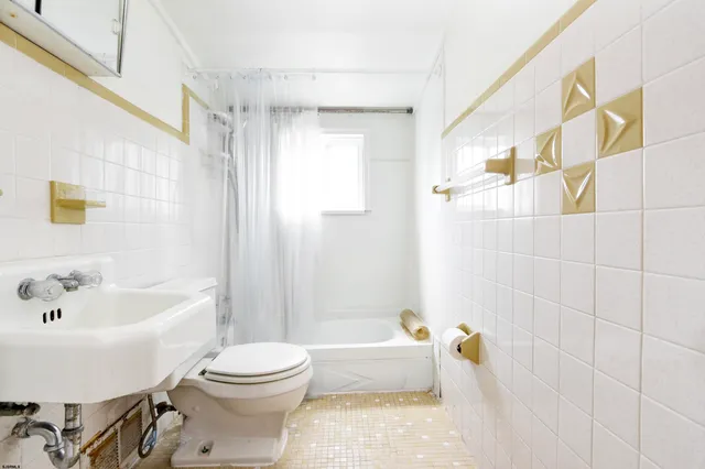 a bathroom with a bathtub toilet and sink