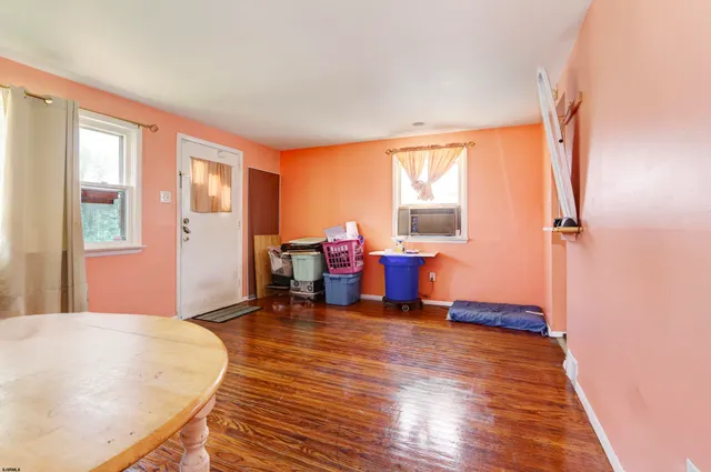 a view of a livingroom with furniture a ceiling fan and wooden floor