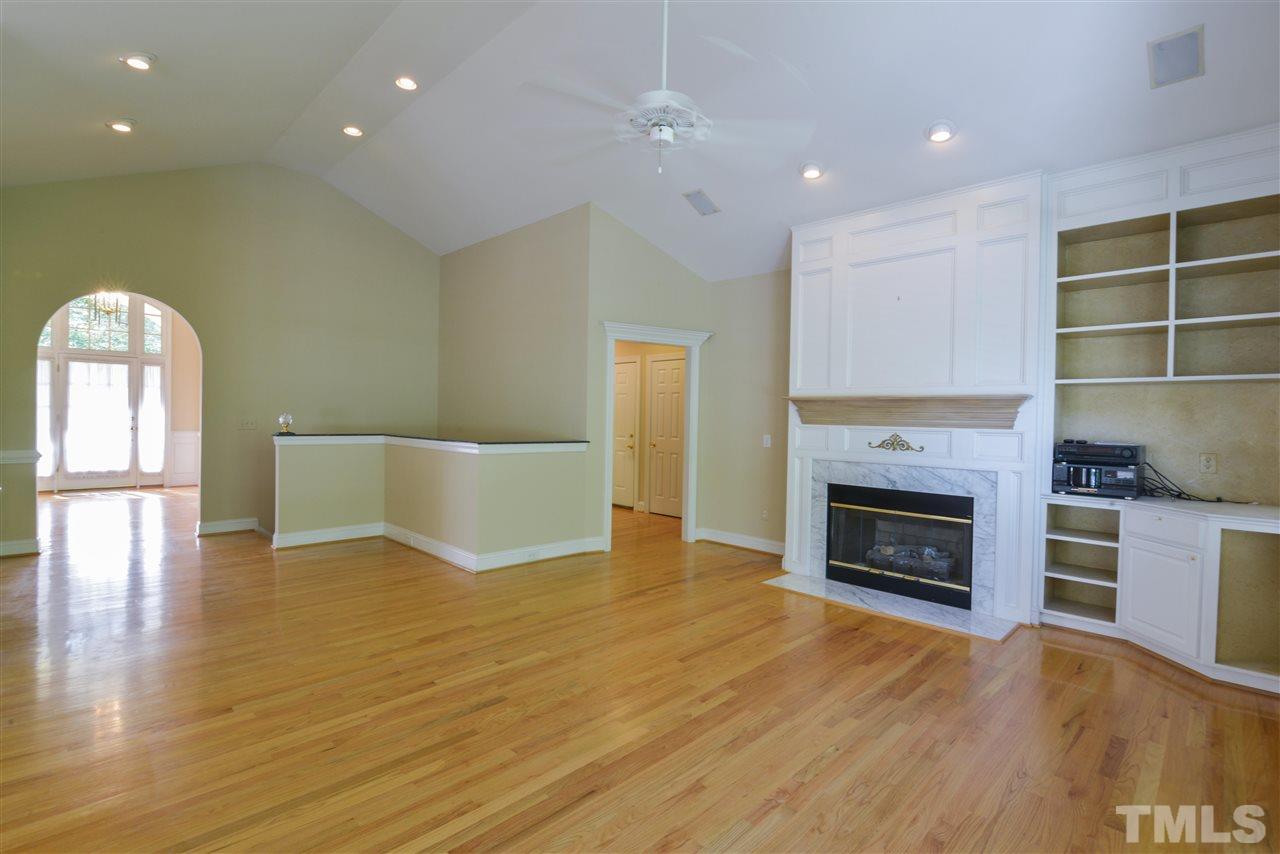7608 Kelmscot Way Raleigh, NC 27615 - Photo 4 of 23 a view of empty room with wooden floor and fireplace