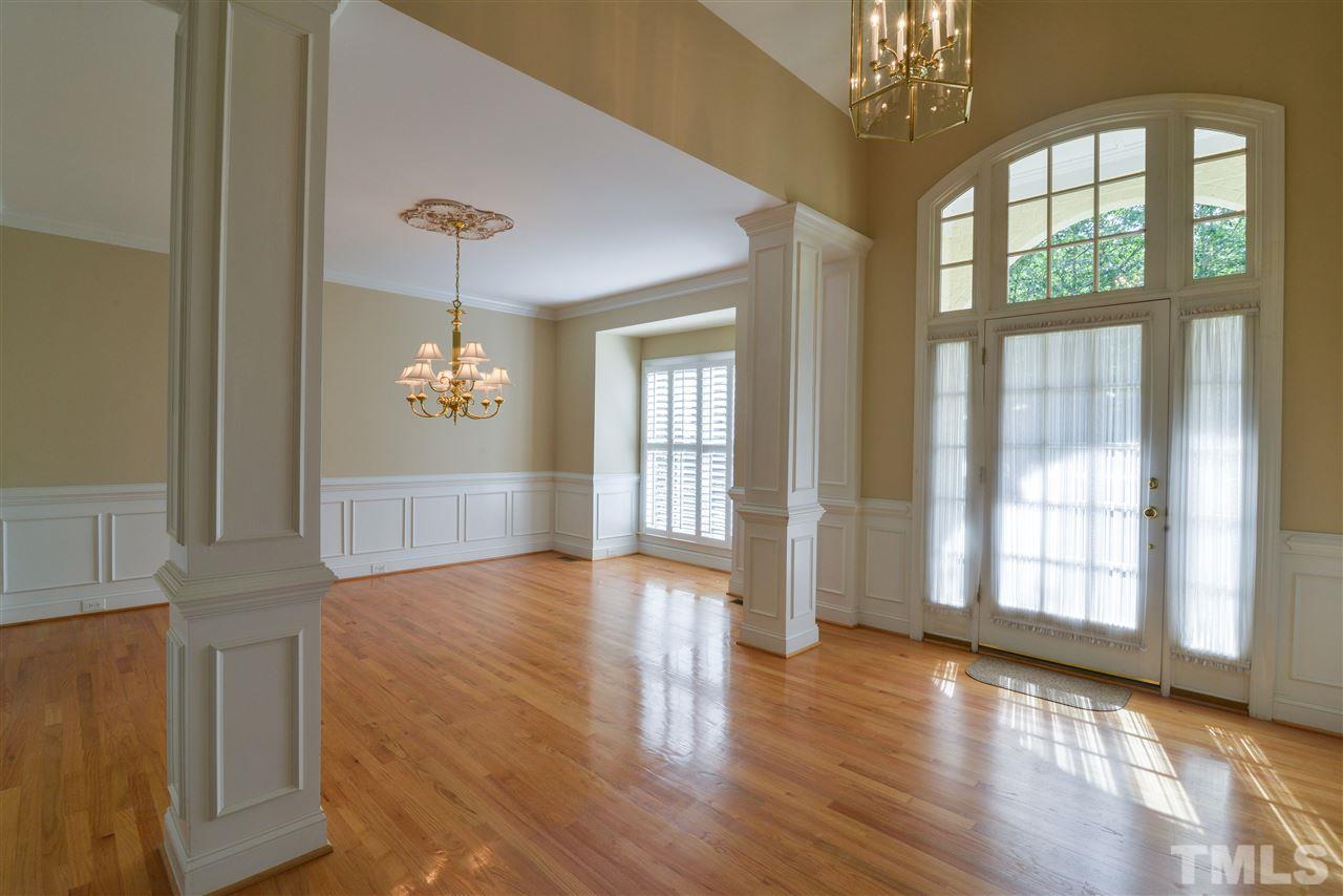 7608 Kelmscot Way Raleigh, NC 27615 - Photo 6 of 23 a view of an empty room with wooden floor and a window