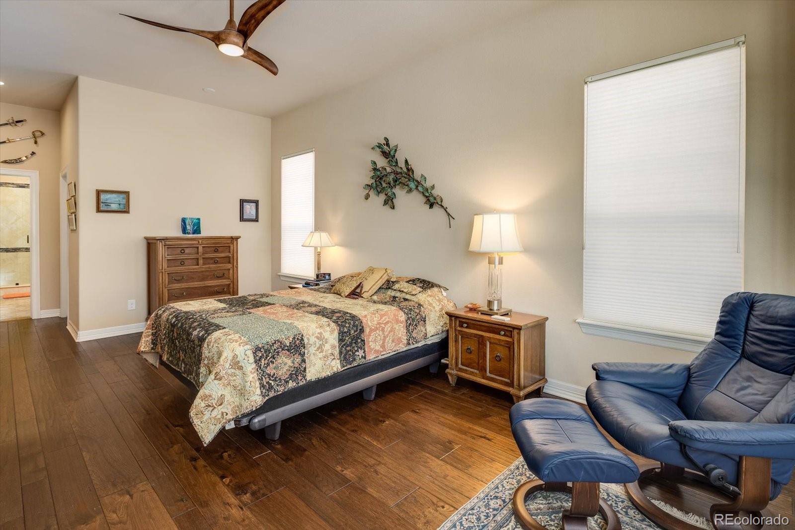 15712 Rito Alto Run Broomfield, CO 80023 - Photo 13 of 26 a bedroom with a bed and wooden floor