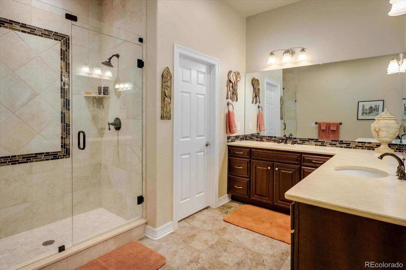 15712 Rito Alto Run Broomfield, CO 80023 - Photo 14 of 26 a bathroom with a sink a mirror and a shower