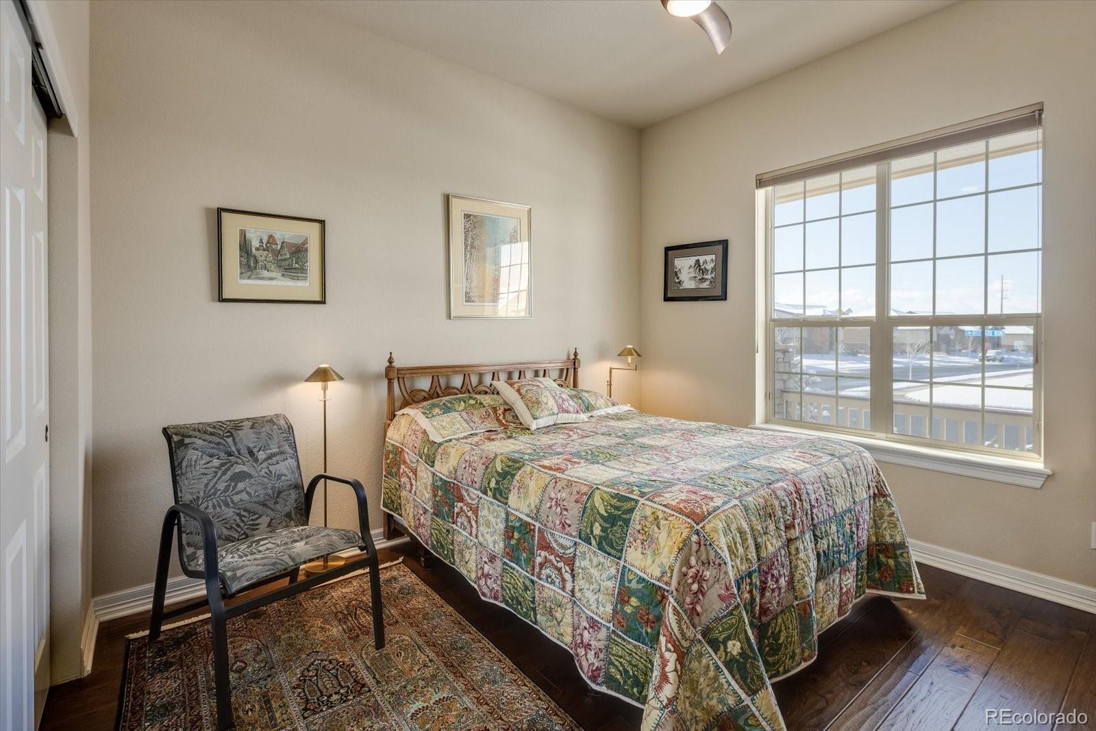 15712 Rito Alto Run Broomfield, CO 80023 - Photo 15 of 26 a bedroom with a bed chair and window