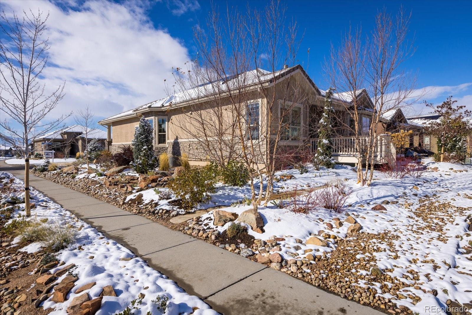15712 Rito Alto Run Broomfield, CO 80023 - Photo 18 of 26 a view of a house with a yard covered in snow