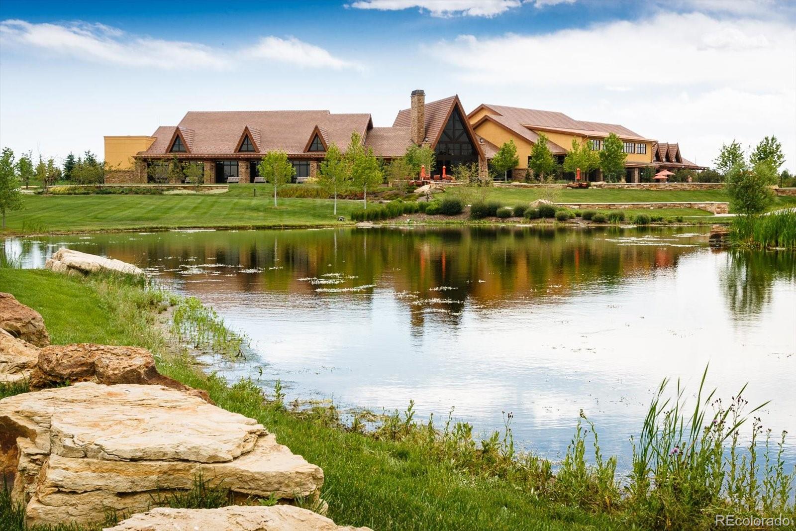 15712 Rito Alto Run Broomfield, CO 80023 - Photo 22 of 26 a view of a lake with a house in the background