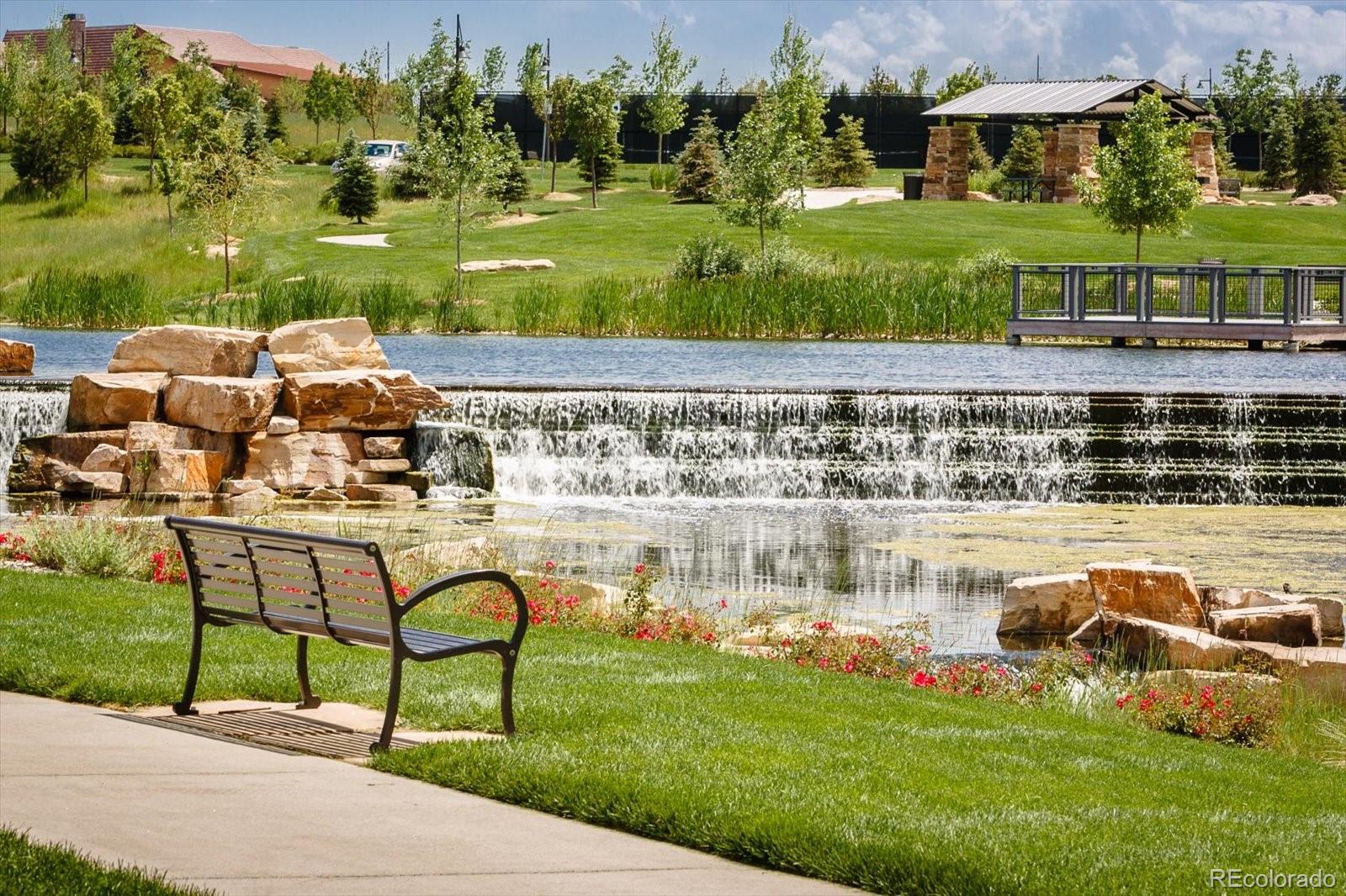 15712 Rito Alto Run Broomfield, CO 80023 - Photo 24 of 26 a view of a lake with lawn chairs and large trees